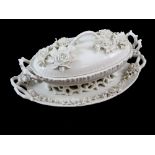 Meissen blanc de chine oval lidded tureen and stand, the tureen modelled with flowers to the cover