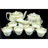 Coalport early 19th century tea service decorated with flowers and highlighted in gilt, comprising