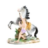 Meissen horse trainer figural group, male figure in purple loincloth with dappled horse on floral