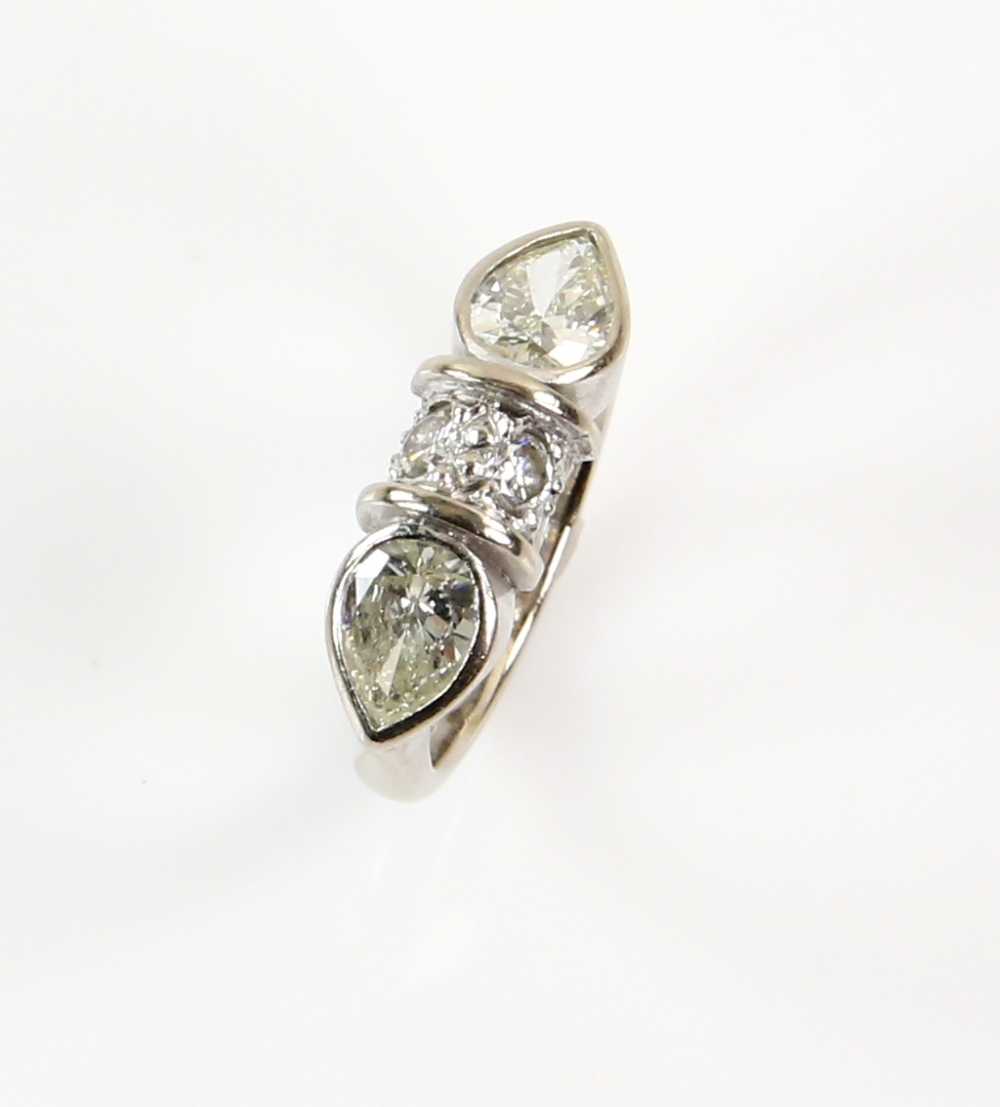 Contemporary diamond ring; two pear form stones with central bezel set with two round cut stones, - Image 2 of 6