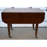 19th century mahogany extending dining table, with drop flaps on turned and reeded supports, and