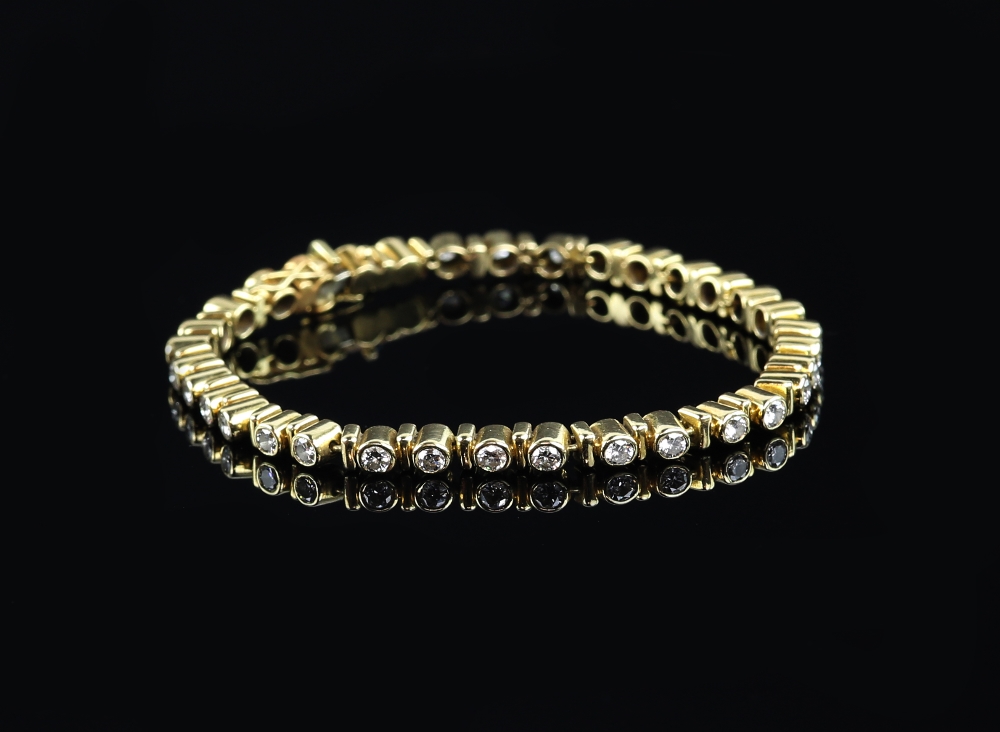 Diamond line bracelet, set with thirty four rub over set round brilliant cut diamonds, estimated