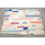 A 1920s patch work quilt with floral panels, interlined, predominately in blue and red 120cm x 176cm