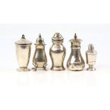 Selectin of five silver pepper cruets, variety of designs and dates.