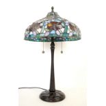 Modern Tiffany style table lamp, the stained glass forming flowers and berries.