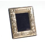 Silver photo frame with variety of toys and teddys in its designs by Art Nouveau .