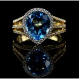 Blue topaz and diamond cocktail ring, pear cut blue topaz, estimated weight 3.23 carats, set in a