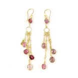 Pair of pink tourmaline earrings, oval faceted stones collet set in a graduated chandelier style