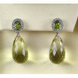 A pair of lemon quartz briolette drop earrings, top of the earrings are set with oval cut peridots