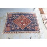 Persian blue ground rug with central lozenge shape medallion 178 x 120 cm .