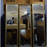 Three gilt framed mirrors .