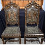Five carved walnut side chairs with embossed leather seats and backs.