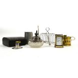 Silver-mounted dressing table pot, small carriage clock, chamber stick, toast rack and mug, napkin