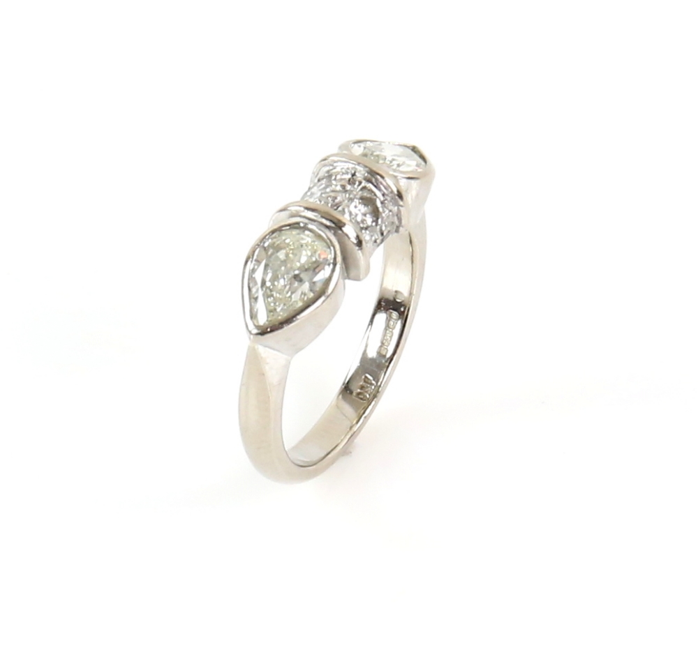 Contemporary diamond ring; two pear form stones with central bezel set with two round cut stones, - Image 3 of 6