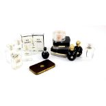Art Deco enamel decorated glass perfume set the central covered box flanked by a scent bottle and