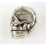 Novelty silver vesta case in the form of a skull, lower mandible opens to insert matches, 52 grams .