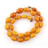 Amber oval bead necklace, largest bead 2.3 x 1.7cm, to smallest bead 1.6 x 1.1cm, strung with knots,