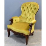 19th Century mahogany button back arm chair on scrolled cabriole legs and castors .