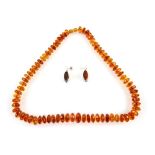 Amber necklace, graduated facetted bead necklace, strung with knots, twist clasp, 59cm in length,