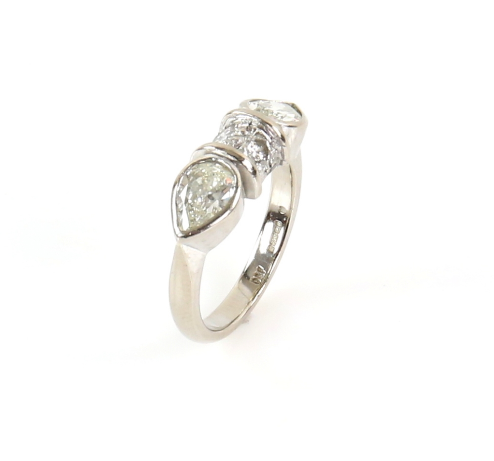 Contemporary diamond ring; two pear form stones with central bezel set with two round cut stones, - Image 4 of 6