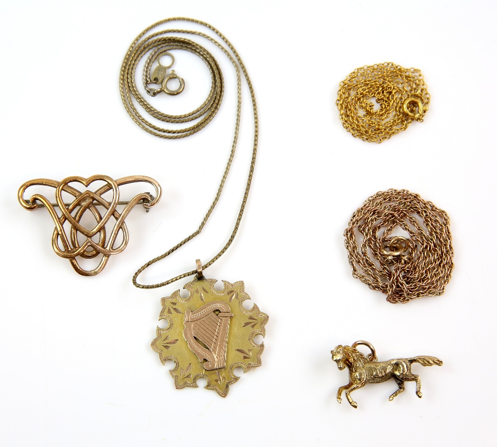 Group of jewellery, including gold medal, horse charm and two chains, all in 9 ct, with a silver