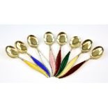 Set of eight Swedish silver and enamel feather design spoons .