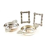 Pair of bamboo design silver photo frames and a pair of silver quaiche form dishes .