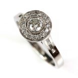 Diamond halo ring, set with round brilliant cut diamonds, with diamond set under gallery, baguette