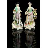 Pair of 19th Century Staffordshire figures of a man and woman, on shaped bases highlighted in