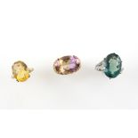 Three gem set rings; oval cut citrine set in 9 ct yellow gold, ring size L, together with similar