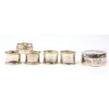 A white metal niello bonbonniere with five silver napkin rings (6).