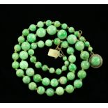 A graduated bead jadeite necklace, largest beads measuring 8.5mm in diameter, strung with knots,