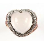 Heart shaped cabochon cut rose quartz ring, set on twisted band mounted with round cut diamonds