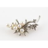 Vintage floral brooch, set with seven cream coloured pearls, 6mm in diameter, mount stamped 14 ct,