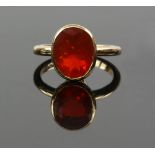 Fire opal ring, rub over set oval cut stone, estimated total weight 2.73 carats, mounted in 9 ct