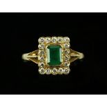 Emerald and diamond cluster ring, central rectangular cut emerald, estimated total weight 0.60