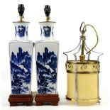 Pair of modern Chinese blue and white lamps decorated with landscape scenes, and a brass and glass