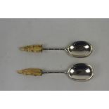 Victorian pair of silver serving spoons, each with bamboo design stems and ivory figural finials, by