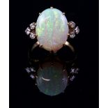 Vintage opal and diamond dress ring, centrally set oval cabochon cut opal, 15 x 12mm, set in-between