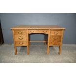 Oak desk with seven drawers.