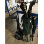 A GOLF TROLLEY WITH GOLF BAG CLUBS