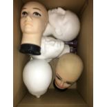 A BOX OF SHOP DUMMY HEADS