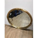 A LARGE GILT FRAMED OVAL MIRROR