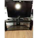 A 37 INCH SAMSUNG TV WITH REMOTE TOGETHER WITH A NICE MODERN GLASS TV UNIT