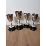 FOUR SILVER PLATED GOLF TROPHIES ON STANDS