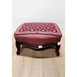 A SMALL BRASS STUDDED UPHOLSTERED FOOTSTOOL