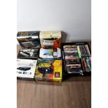 A BOX OF ELECTRONICS INCLUDING FREEVIEW BOXES AND A BINATONE TV GAME TOGETHER WITH A BOX OF DVDS
