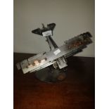 A DESK ORNAMENT OF A METAL TRIPLANE DIVING