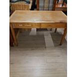 AN OAK TWO DRAWER WRITING TABLE