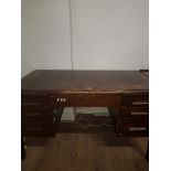 A TWIN PEDESTAL SEVEN DRAW WRITING DESK